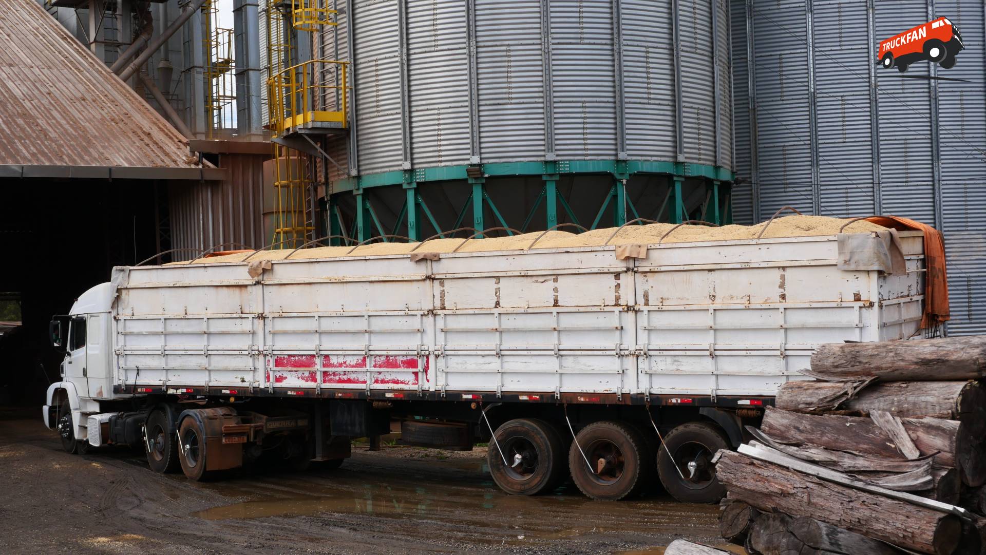 Oude truck en volgeladen trailer bij sojaverwerker